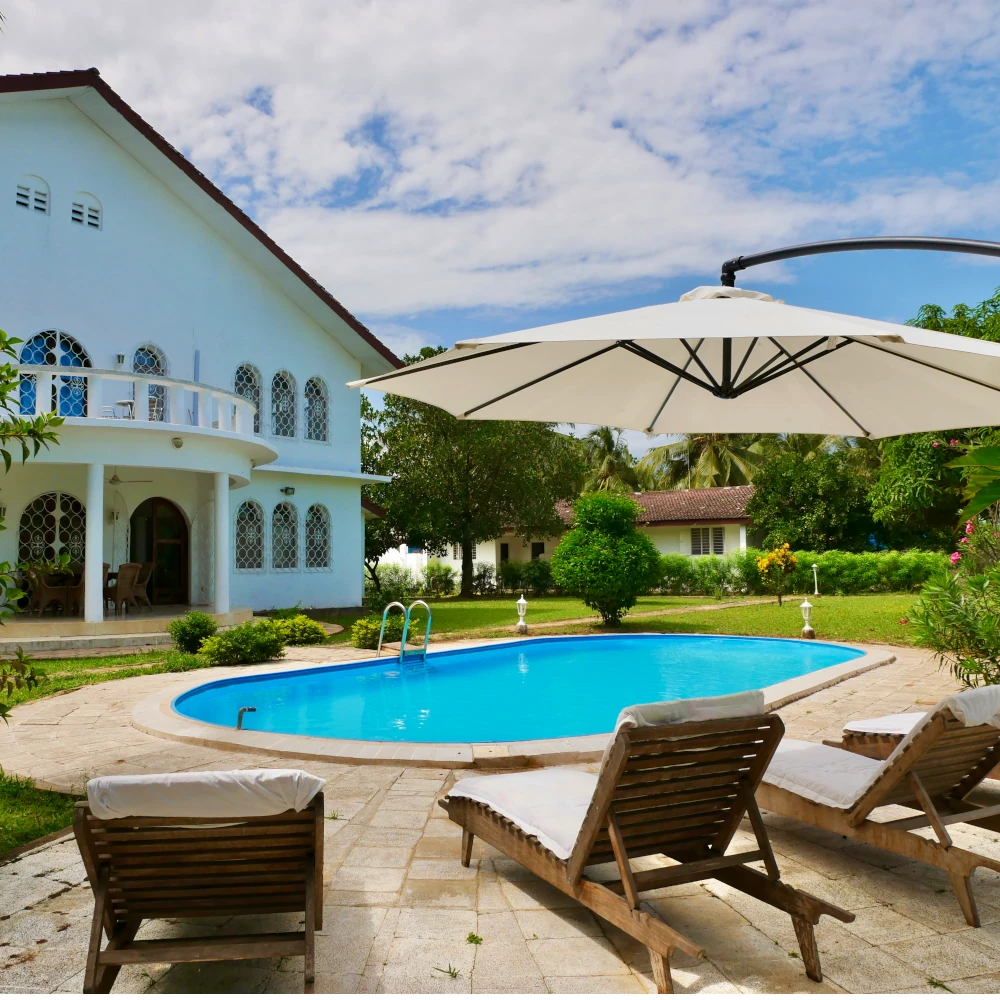 Private beachfront villa with pool and sun loungers at Villa Heidi Zanzibar