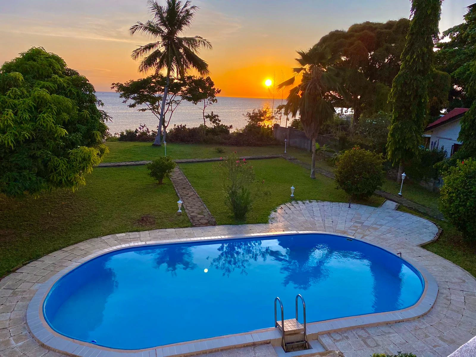 Sunset over the ocean at Villa Heidi Zanzibar with private pool and tropical garden